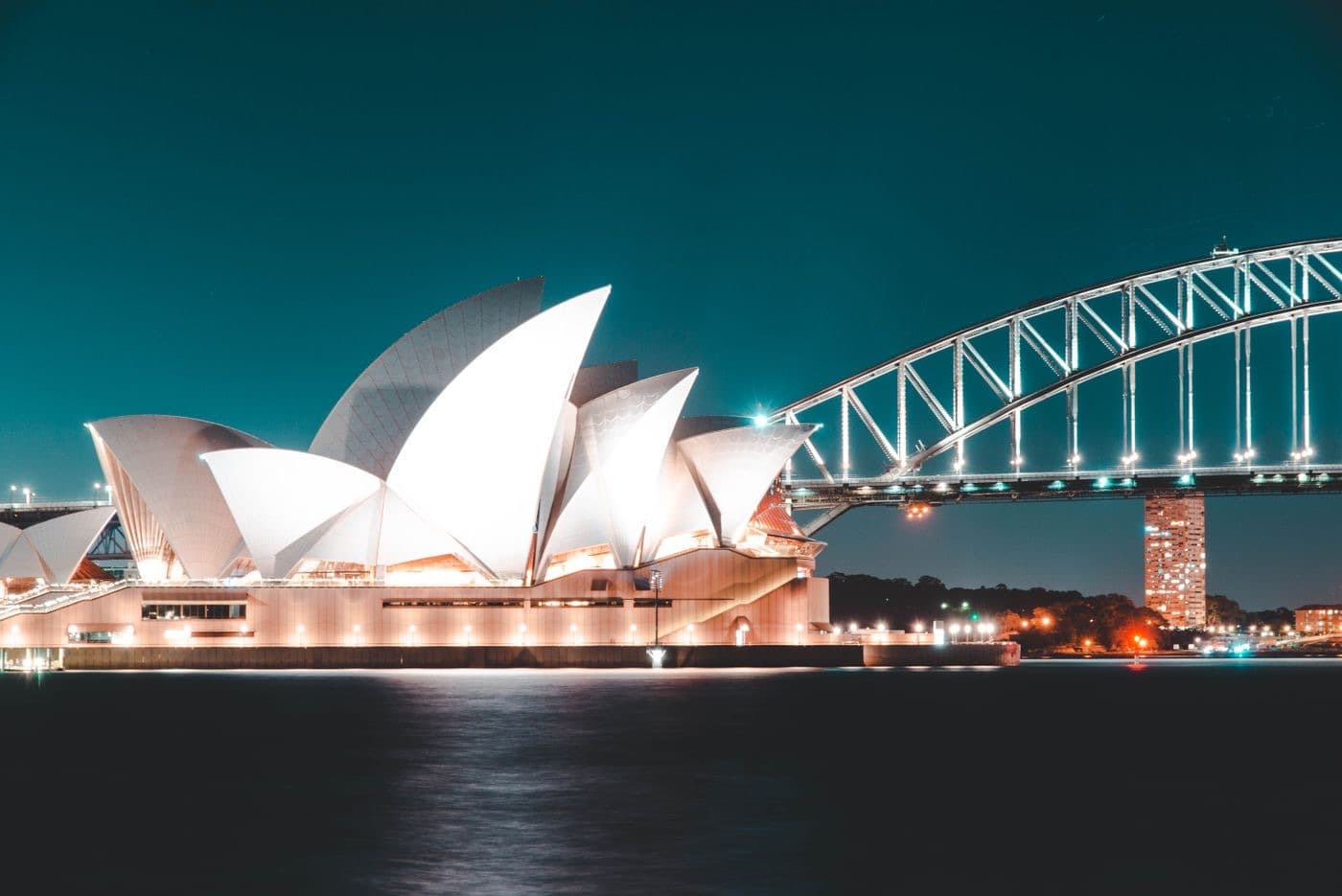 Sydney Opera House and Harbour Bridge illuminated at night — iconic Sydney Australia